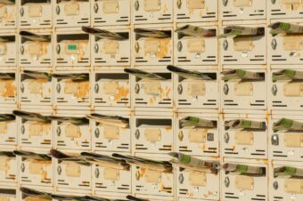 a wall of mailboxes with a newsletter in almost every slot
