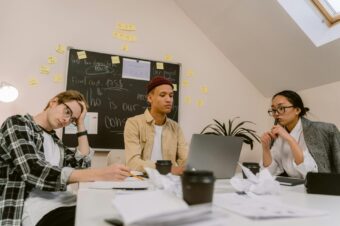 exhausted employees sitting at a disorganized table